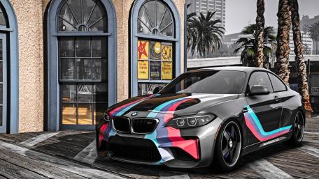 Sleek BMW M2 with Vibrant Design in Urban Setting wallpaper