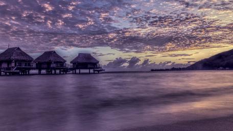 Serene Purple Twilight Over Water Bungalows wallpaper