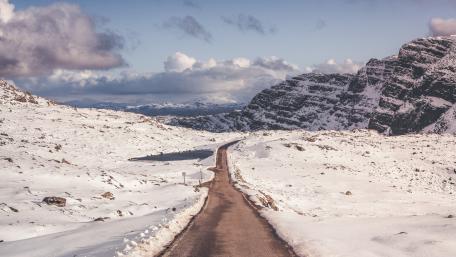Winter Road Through Snowy Mountain Pass wallpaper
