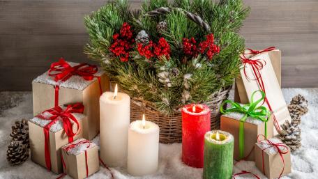 Festive Christmas Arrangement with Candles and Gifts wallpaper