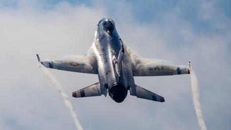 Fighter Jet in Action Against the Clouds wallpaper