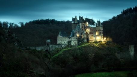 Mystical Castle Amidst Enchanted Landscape wallpaper