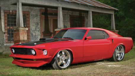 Red Vintage Muscle Car Under a Rustic Porch wallpaper