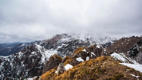 Majestic Mountain Summit Under Cloudy Skies wallpaper