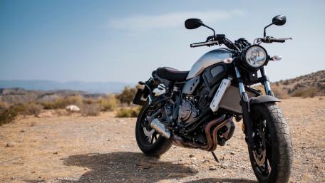Sleek Modern Motorcycle in Scenic Landscape wallpaper