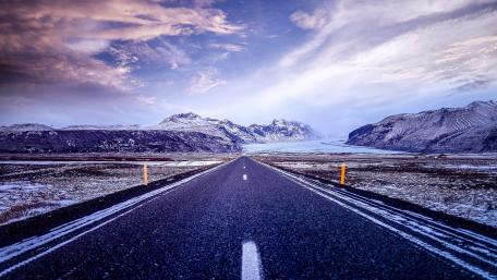 Majestic Road Through Snowy Mountains wallpaper