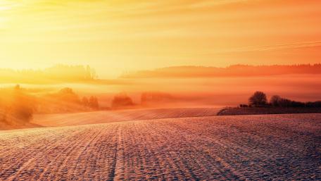 Serene Winter Sunrise Over Rolling Hills wallpaper