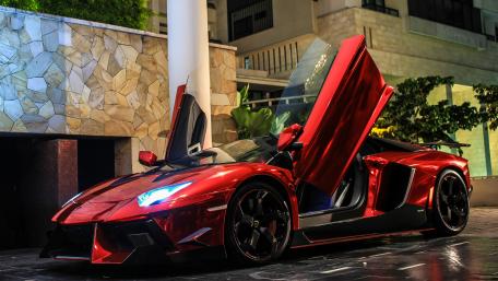 Red Lamborghini Aventador SV Under City Lights wallpaper