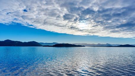 Serene Blue Waters and Clouds Over Landscape wallpaper