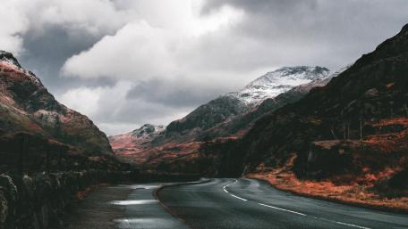 Curving Road Through Autumn Valley Landscape wallpaper
