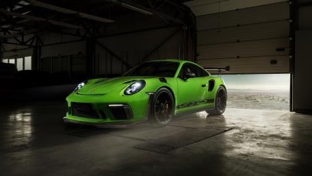Vibrant Porsche GTS in a Modern Garage Setting wallpaper