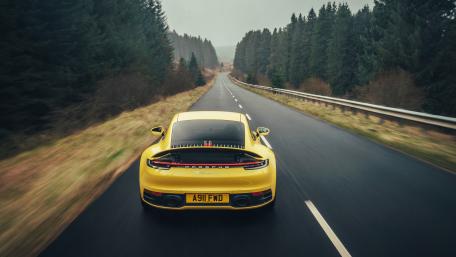 Sleek Porsche on a Scenic Road wallpaper