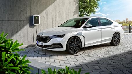Sleek Electric Car Charging in Modern Setting wallpaper
