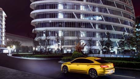Vibrant Yellow Car Under City Lights wallpaper