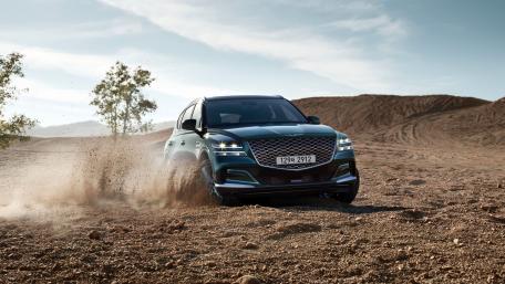 Sleek SUV in Action on Sandy Terrain wallpaper