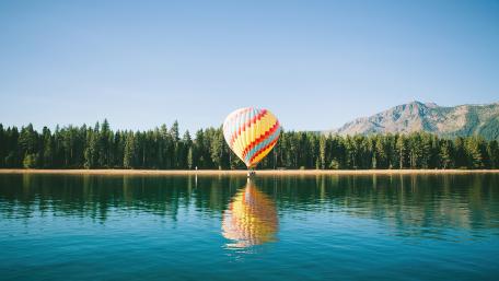 Serene Hot Air Balloon Reflection on Tranquil Lake wallpaper