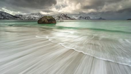 Mysterious Coastal Seascape with Bold Boulder and Gentle Waves wallpaper