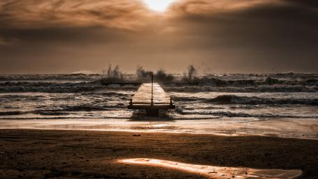 Serene Pier Embraced by Waves and Sunlight wallpaper
