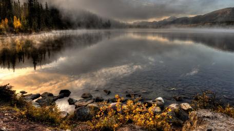 Serene Autumn Lake Reflection in Misty Landscape wallpaper