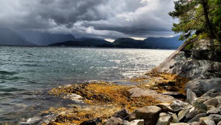 Serene Lake Under Dramatic Clouds wallpaper