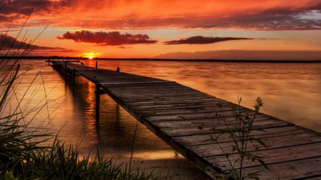 Serene Sunset Over Tranquil Lake Pier wallpaper