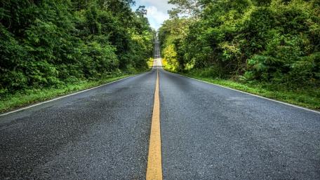 Serene Road Through Lush Greenery wallpaper