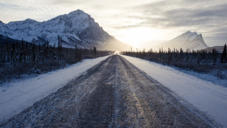 Winter Road Through Snowy Mountainscape wallpaper