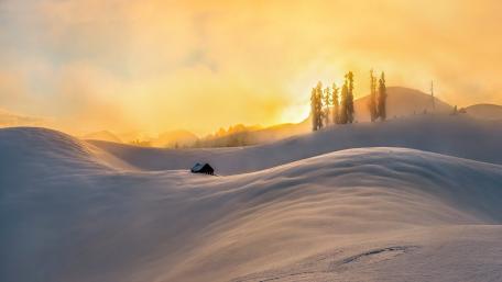 Serene Snowy Hills Under a Golden Sky wallpaper