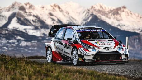 Powerful Rally Car Racing Through Majestic Mountains wallpaper
