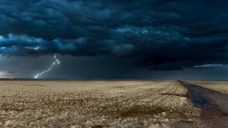 Dramatic Lightning Over Vast Field Scene wallpaper