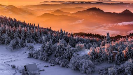 Serene Winter Dawn Over Majestic Mountains wallpaper