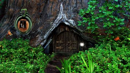 Enchanted Hobbit Tree House Nestled in Nature wallpaper
