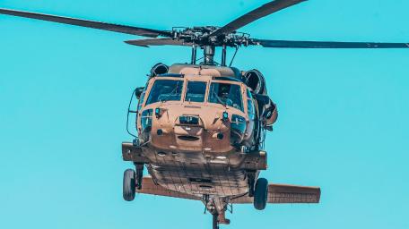 Powerful Helicopter in Flight Over Blue Sky wallpaper