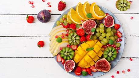 Vibrant Fruit Salad on Wooden Planks wallpaper