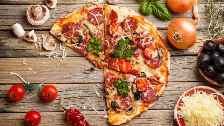 Delicious Italian Pizza on Rustic Wood Planks wallpaper