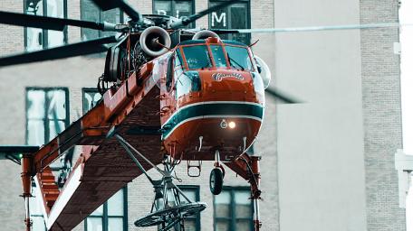 Vibrant Helicopter in Action Over Urban Landscape wallpaper