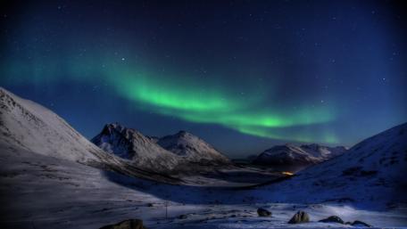 Dancing Aurora over Snowy Peaks wallpaper