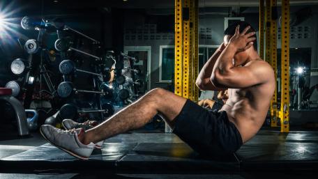 Intense Sit-up Workout in Gym wallpaper