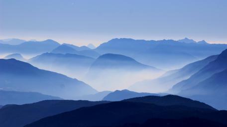 Majestic Blue Mountain Layers in Foggy Landscape wallpaper