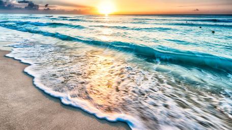 Golden Waves at Sunset Over Tranquil Beach wallpaper
