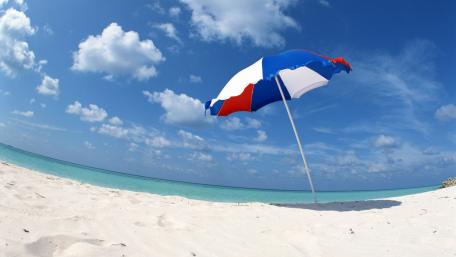 Vibrant Beach Scene with Umbrella Perspective wallpaper
