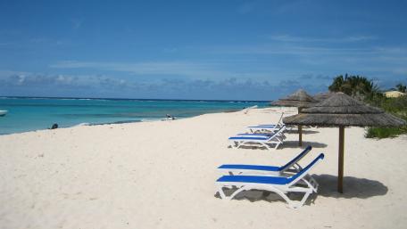 Tranquil Beachside Bliss with Palapas and Sunbeds wallpaper