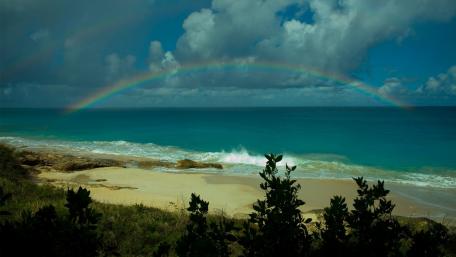 Vibrant Rainbow over Serene Beach Landscape wallpaper