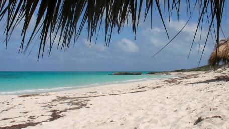 Tranquil Beach Escape Amidst Serene Waters wallpaper