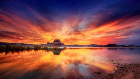 Vibrant Sunset Over Tranquil Lake Waters wallpaper