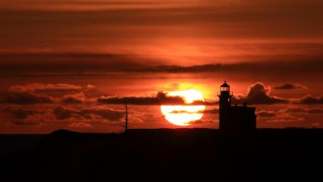 Sunset Serenity with Lighthouse Silhouette wallpaper