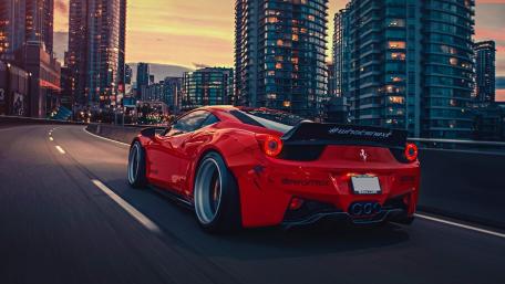 Red Ferrari Dominates City Streets wallpaper