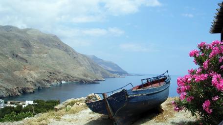 Serene Bay with Abandoned Boat and Flowers wallpaper