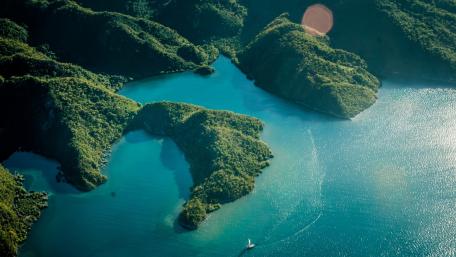 Serene Coastal Aerial View of Lush Landscapes wallpaper