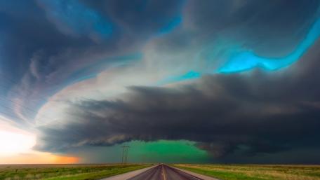 Dramatic Storm Clouds Over Open Road wallpaper
